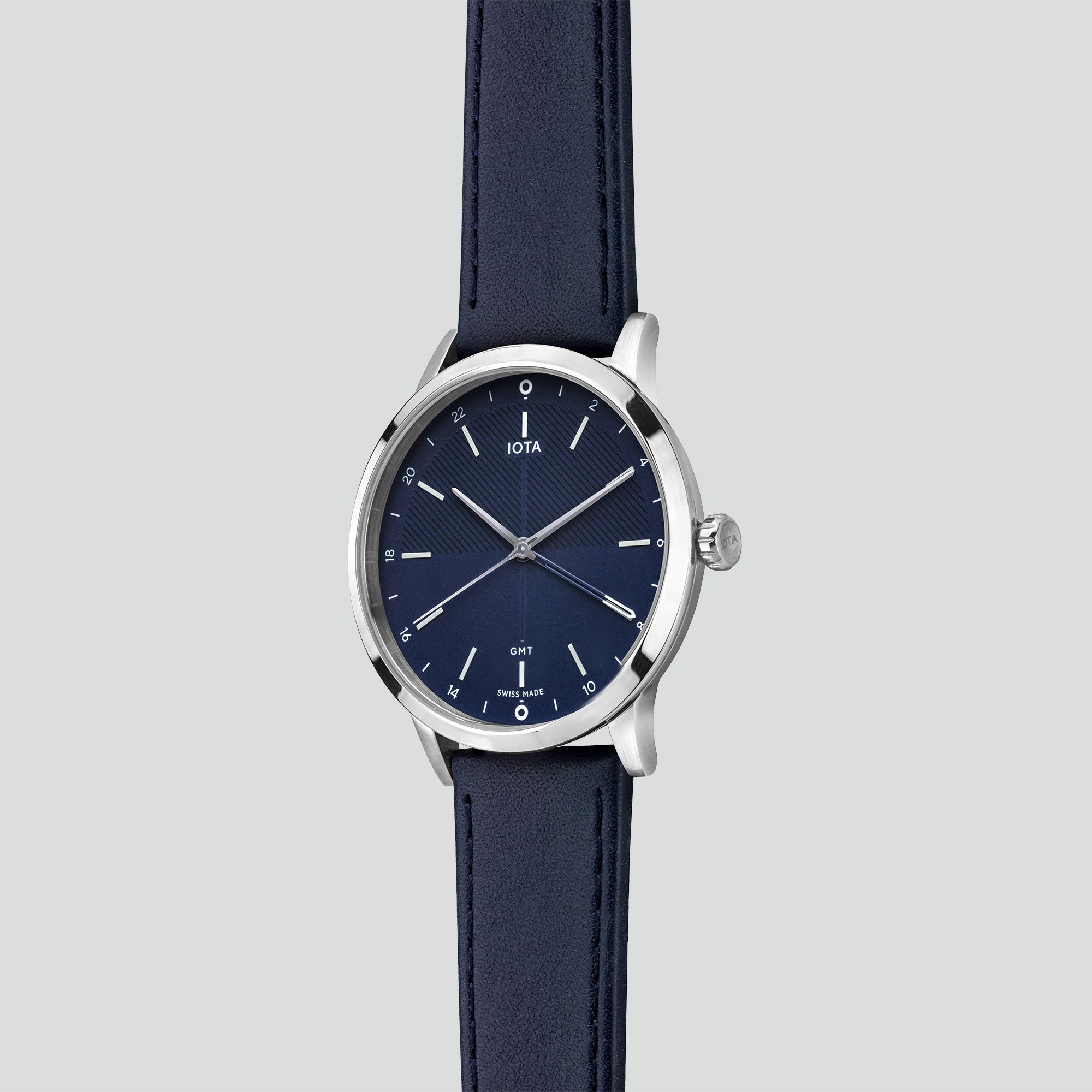 A side profile of the IOTA Sydney GMT watch with blue dial, a polished 316L stainless steel case housing a blue nappa leather watch strap